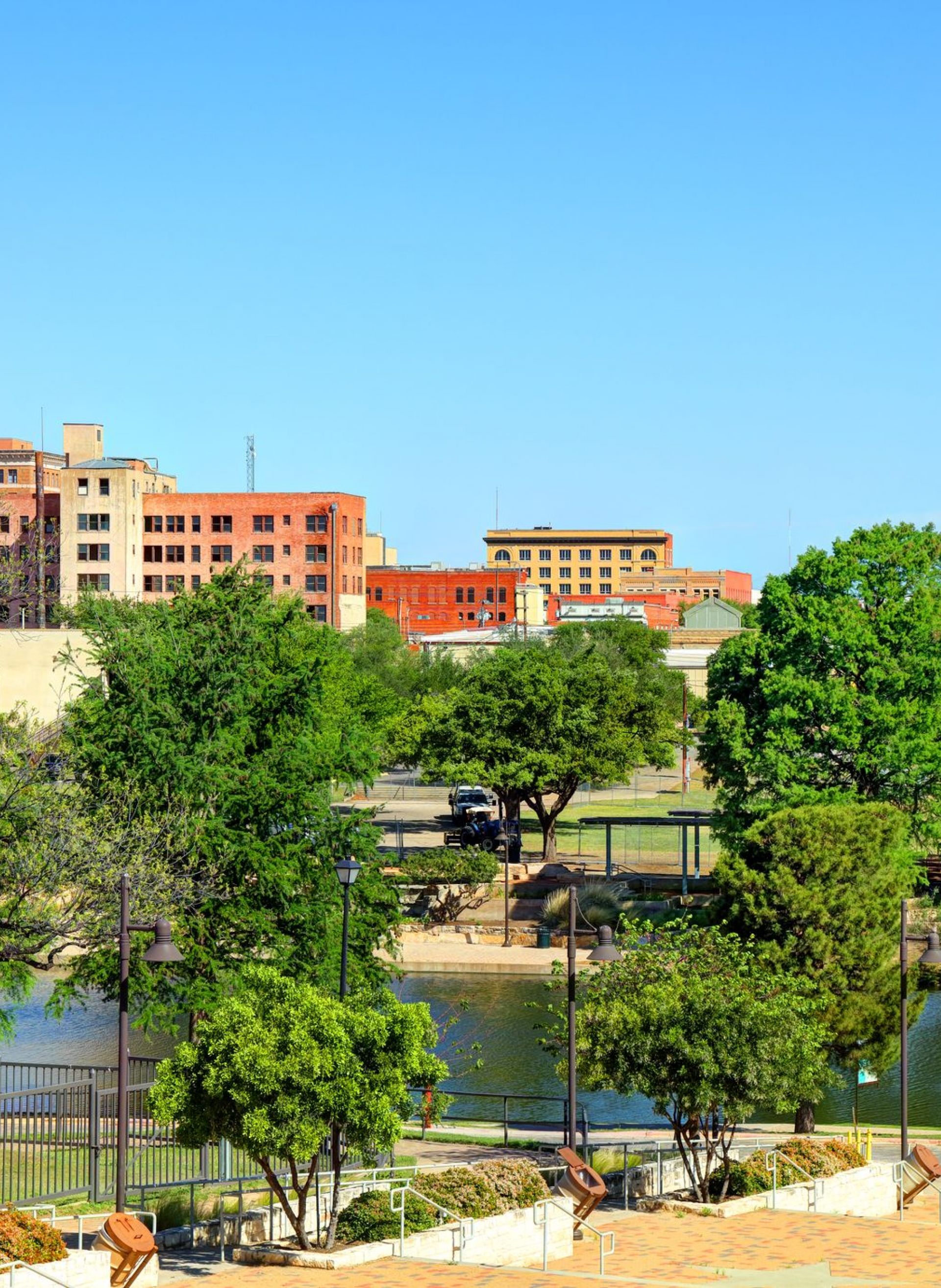 San Angelo Texas waterway with trees and buildings