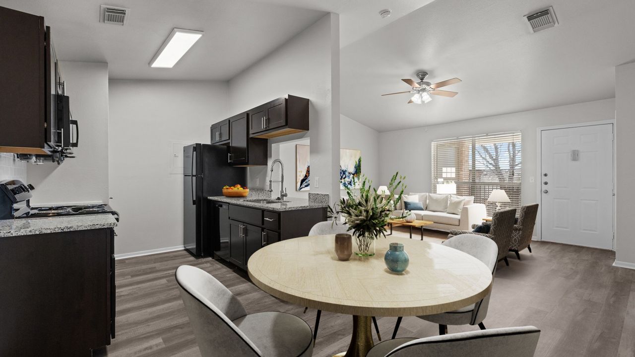 Encino Park apartments home interior with open floor plan showing kitchen, dining area and living room